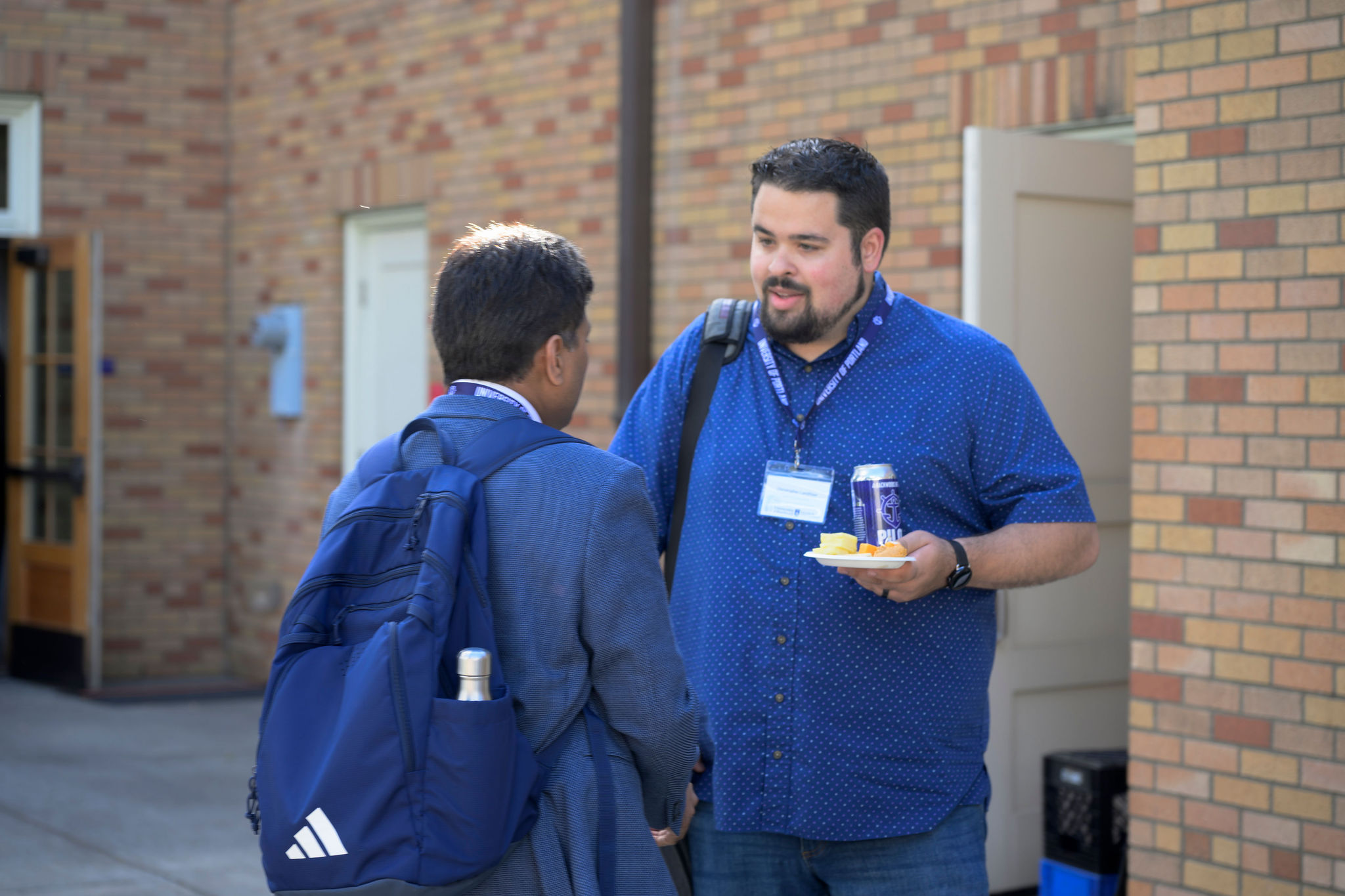 Chris Landtiser talking with an attendee at the National Catholic Education & AI Conference
